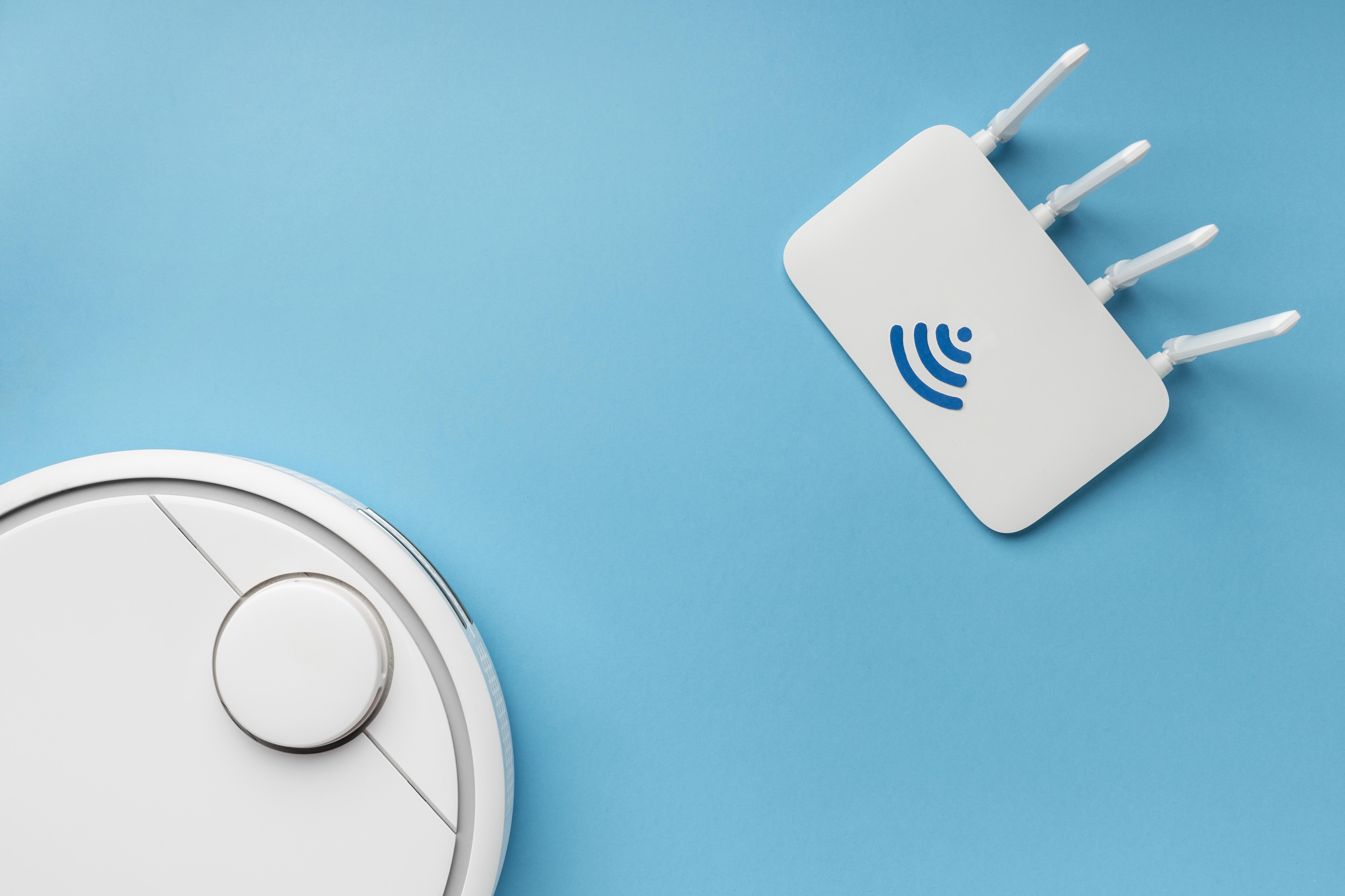 Top view of a wi-fi router with a vacuum cleaner, representing wi-fi router price (harga router wifi)