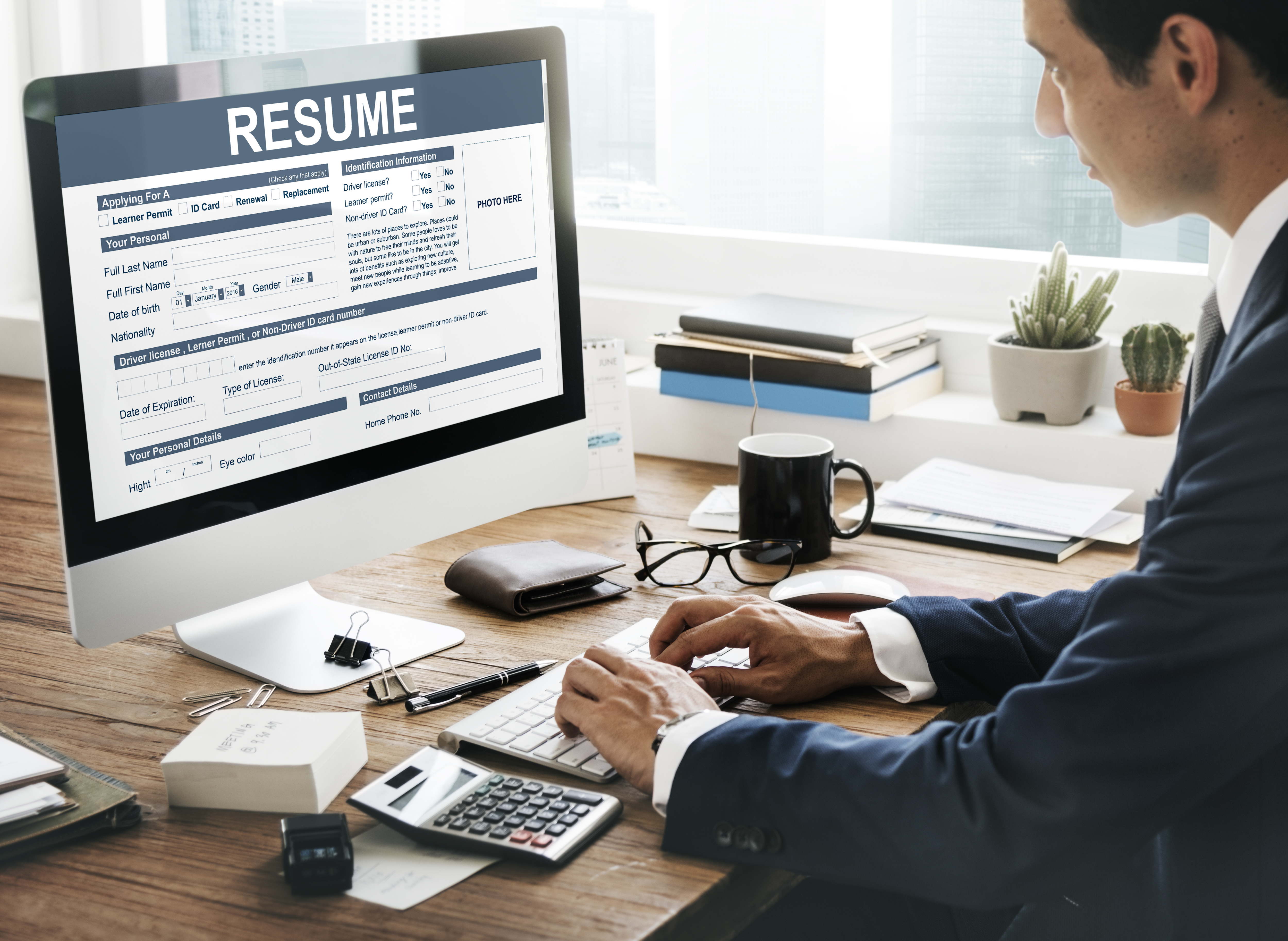 Man working on a resume on his computer.