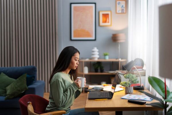 A medium shot of a woman working from home in a comfortable outfit, as an illustration of how wifi mesh works.